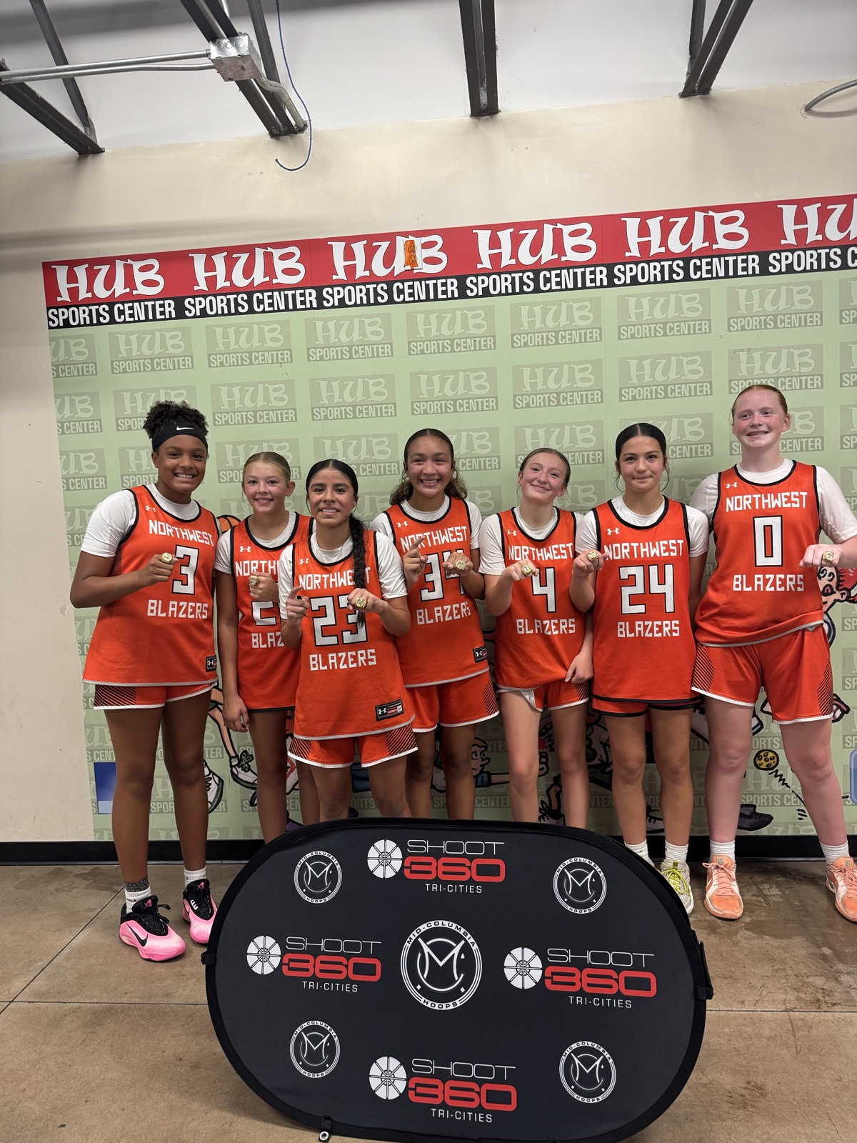 Northwest Blazers team photo in front of Hub Sports Center backdrop.