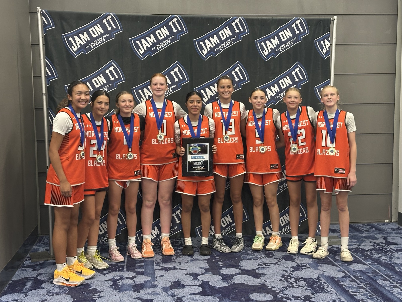 Northwest Blazers team photo with medals and championship plaque.