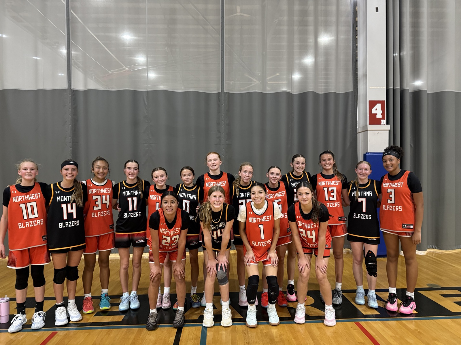 Northwest and Montana Blazers athletes posing together on court.